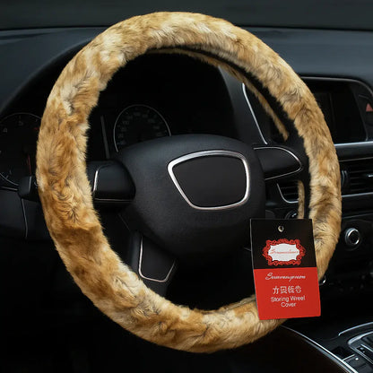 Fluffy brown steering wheel cover on a car steering wheel with a brand tag.
